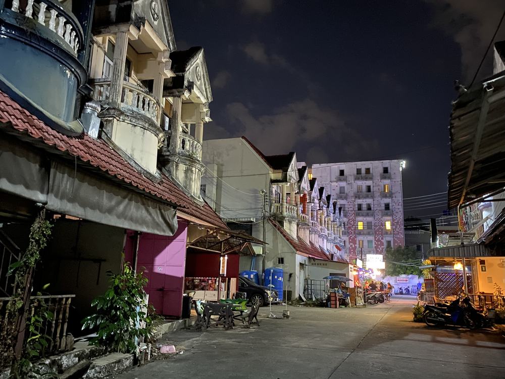 Phuket street at night with shop lights, illustrating evening living costs newcomers budget for